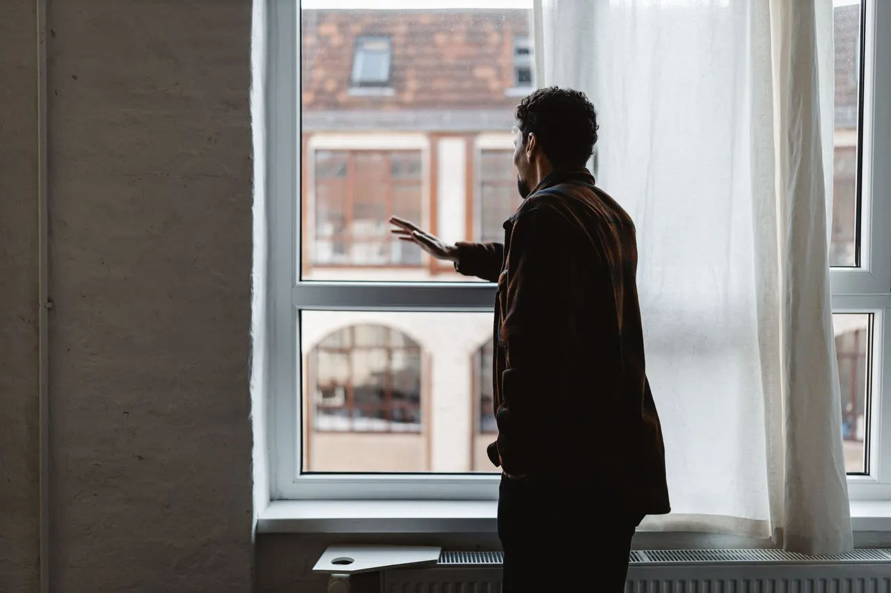 A person looking out of an office window