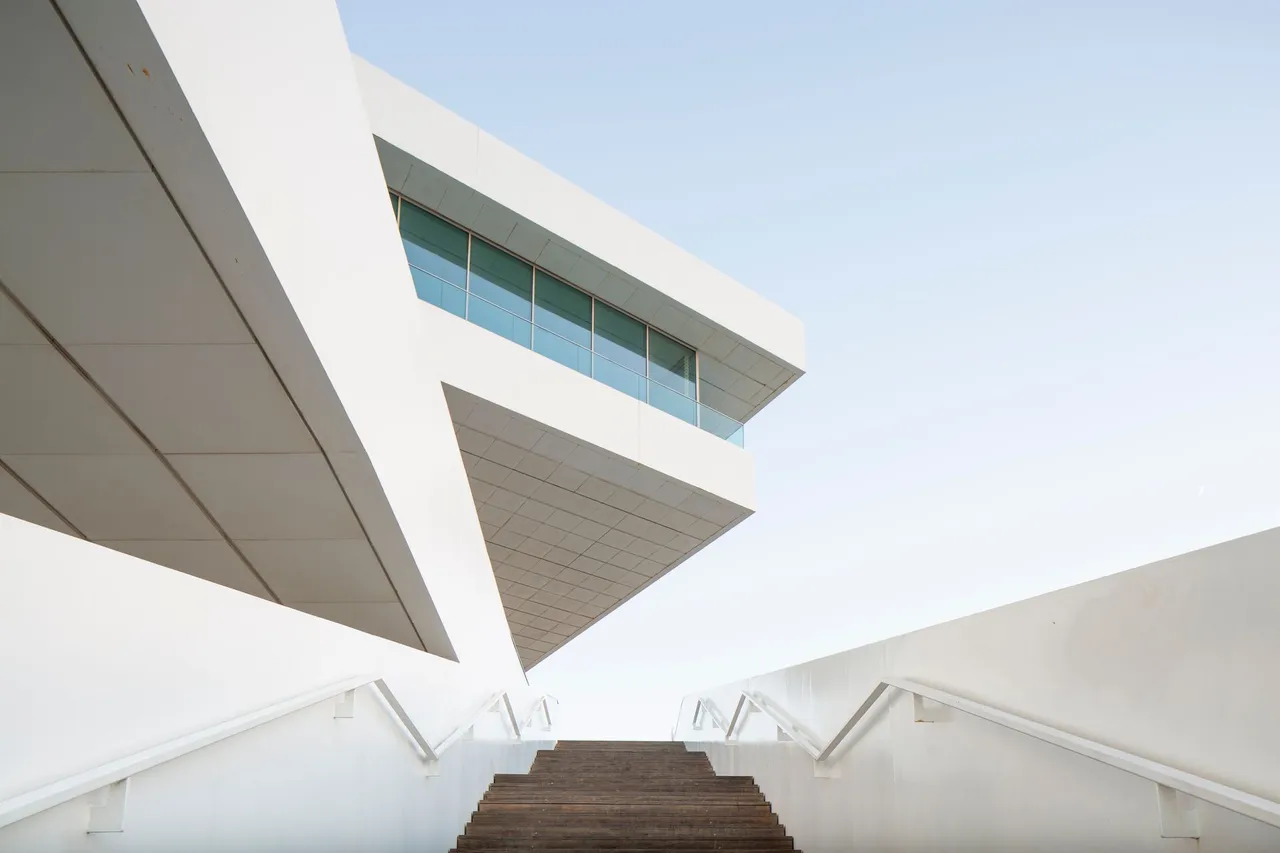 The angular white facade of a modern building